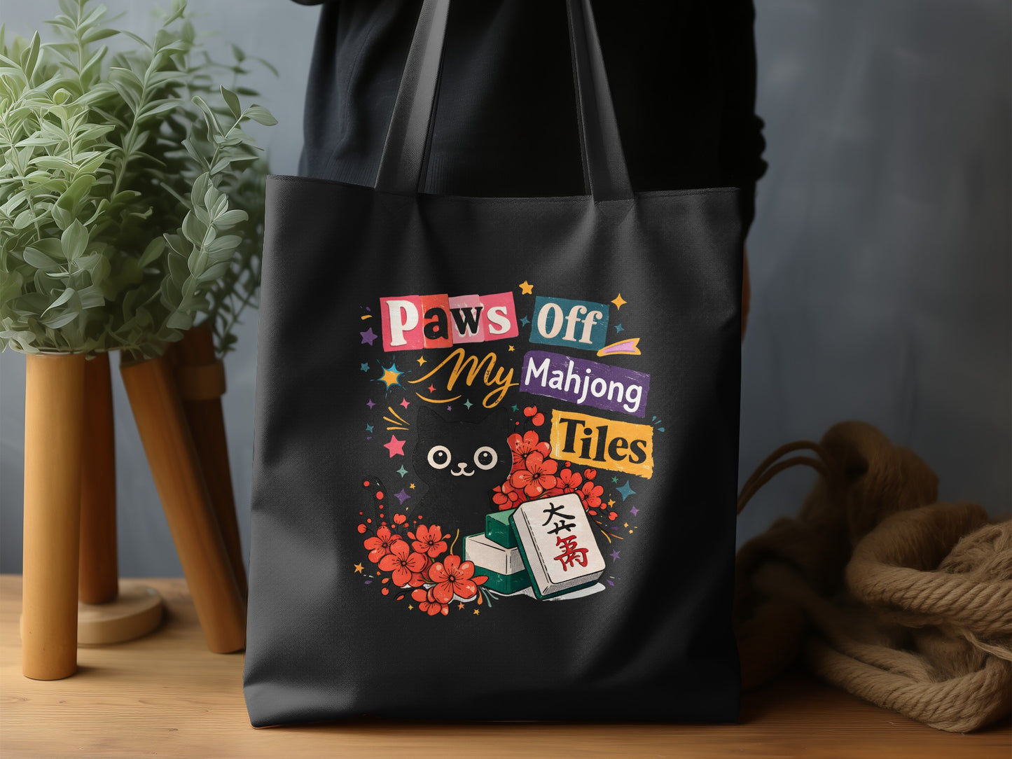 Black tote bag with "Paws Off My Mahjong Tiles" and cartoon cat graphic.
