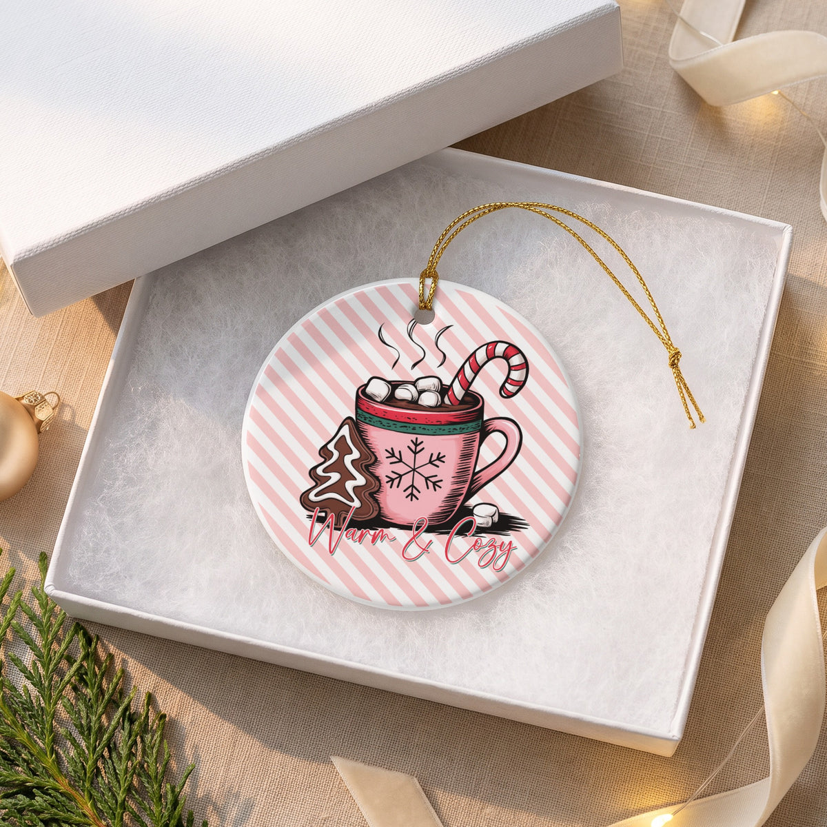 Round ornament with hot chocolate, gingerbread tree, and "Warm & Cozy" text.