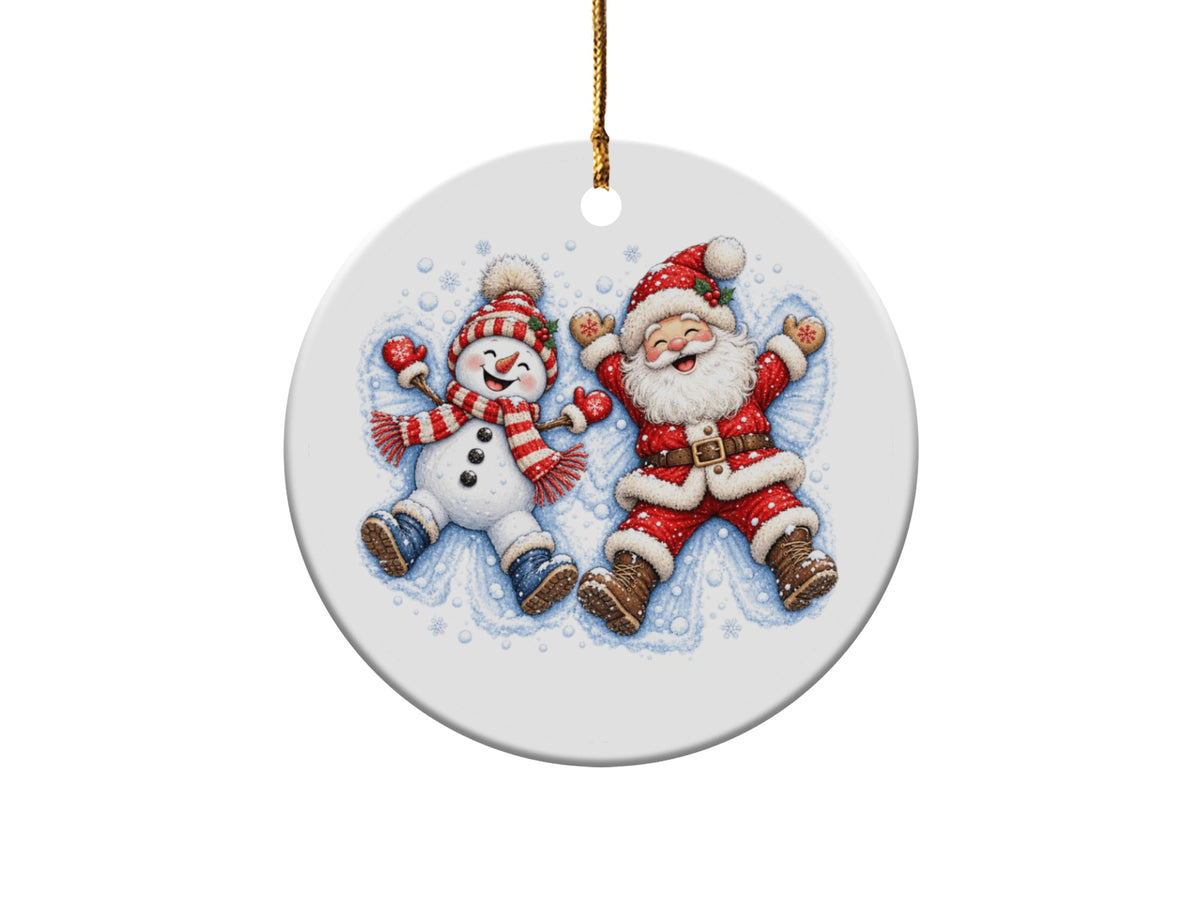 Round ornament featuring a cheerful snowman and Santa Claus lying in snow.