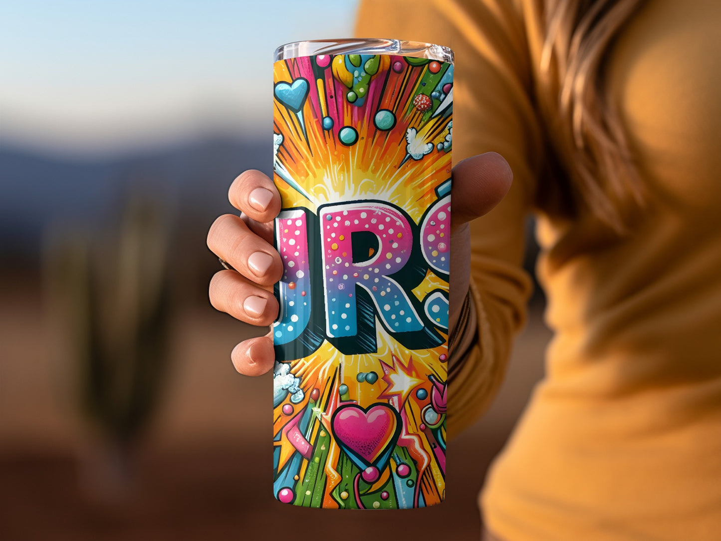 Tumbler with colorful "JR" text and pop art style hearts and stars.
