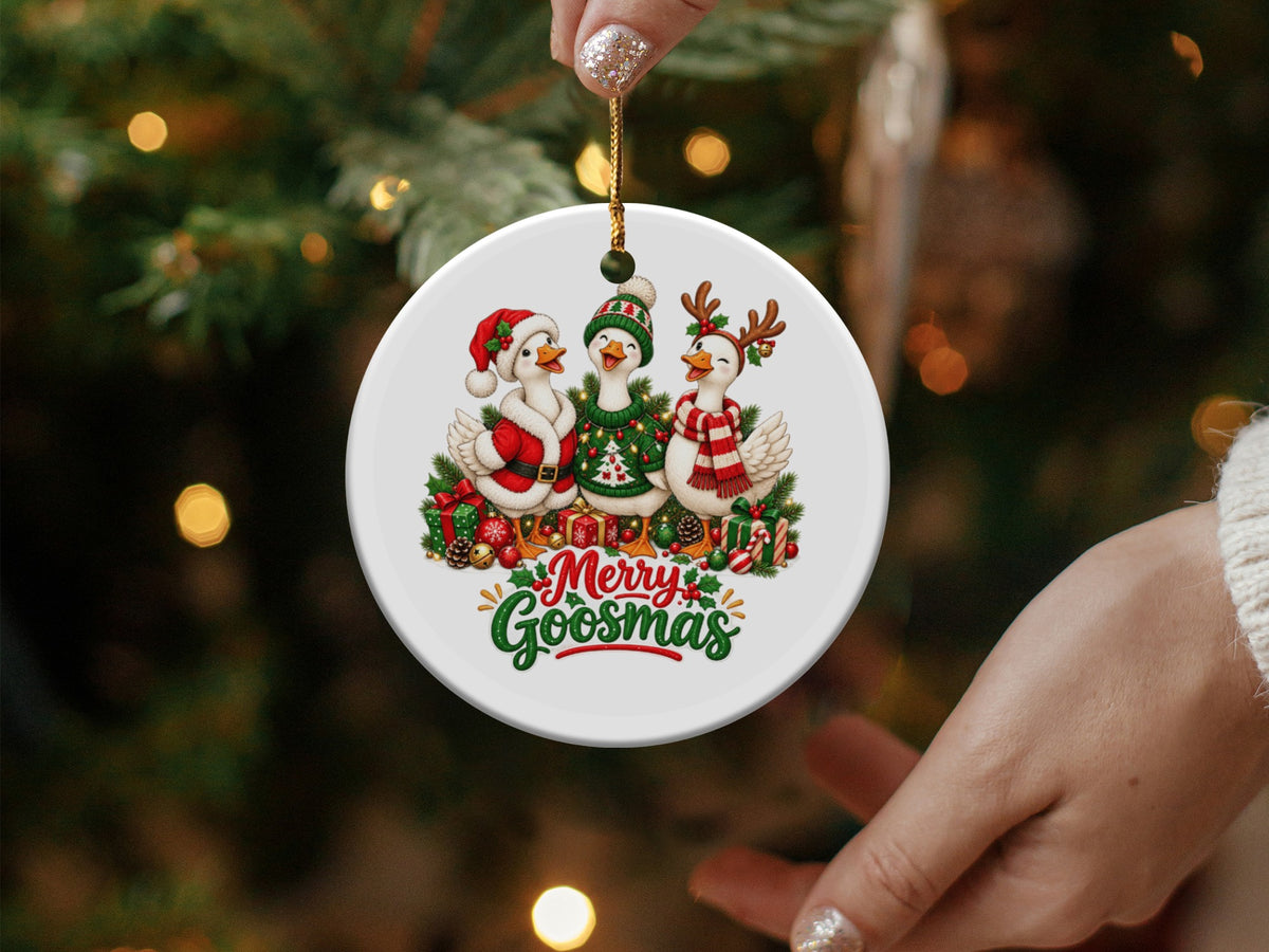 Round ornament with three geese dressed for Christmas and text "Merry Goosmas."