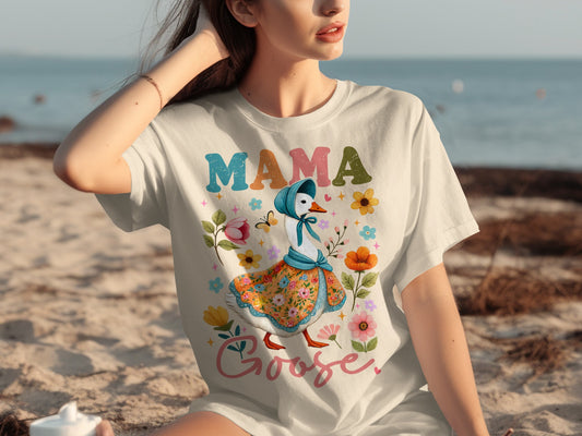 White t-shirt with "Mama Goose" text and a goose in a floral dress.