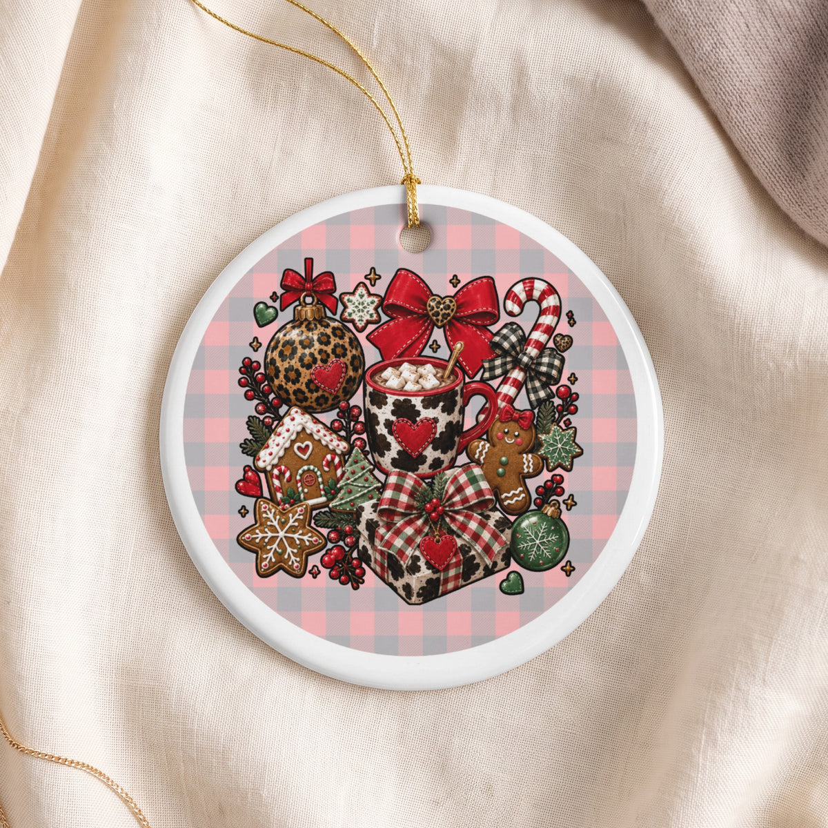 Round ceramic ornament with festive Christmas icons and a pink plaid background.