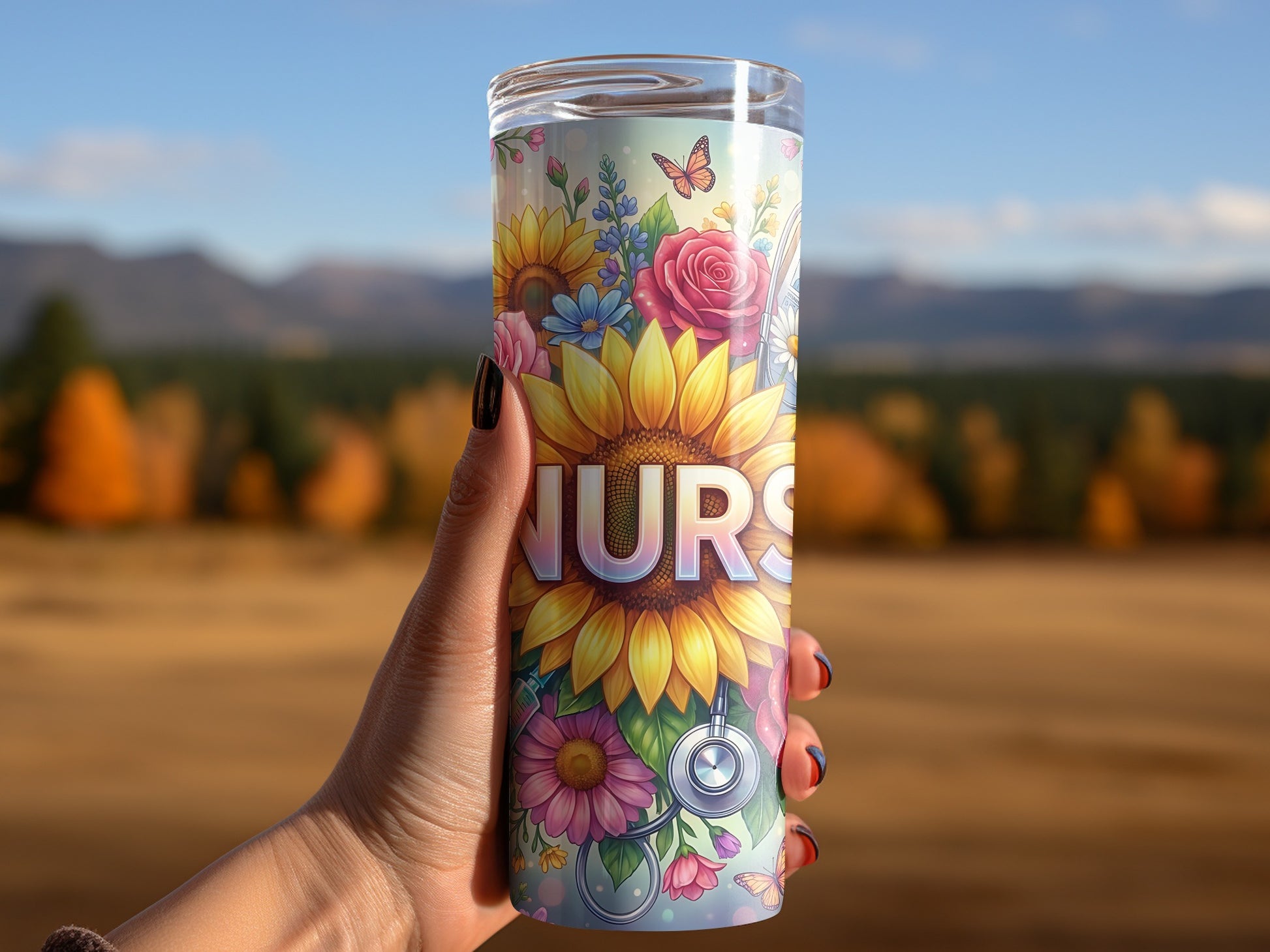 Tumbler with floral art and "NURS" text, held by a hand.