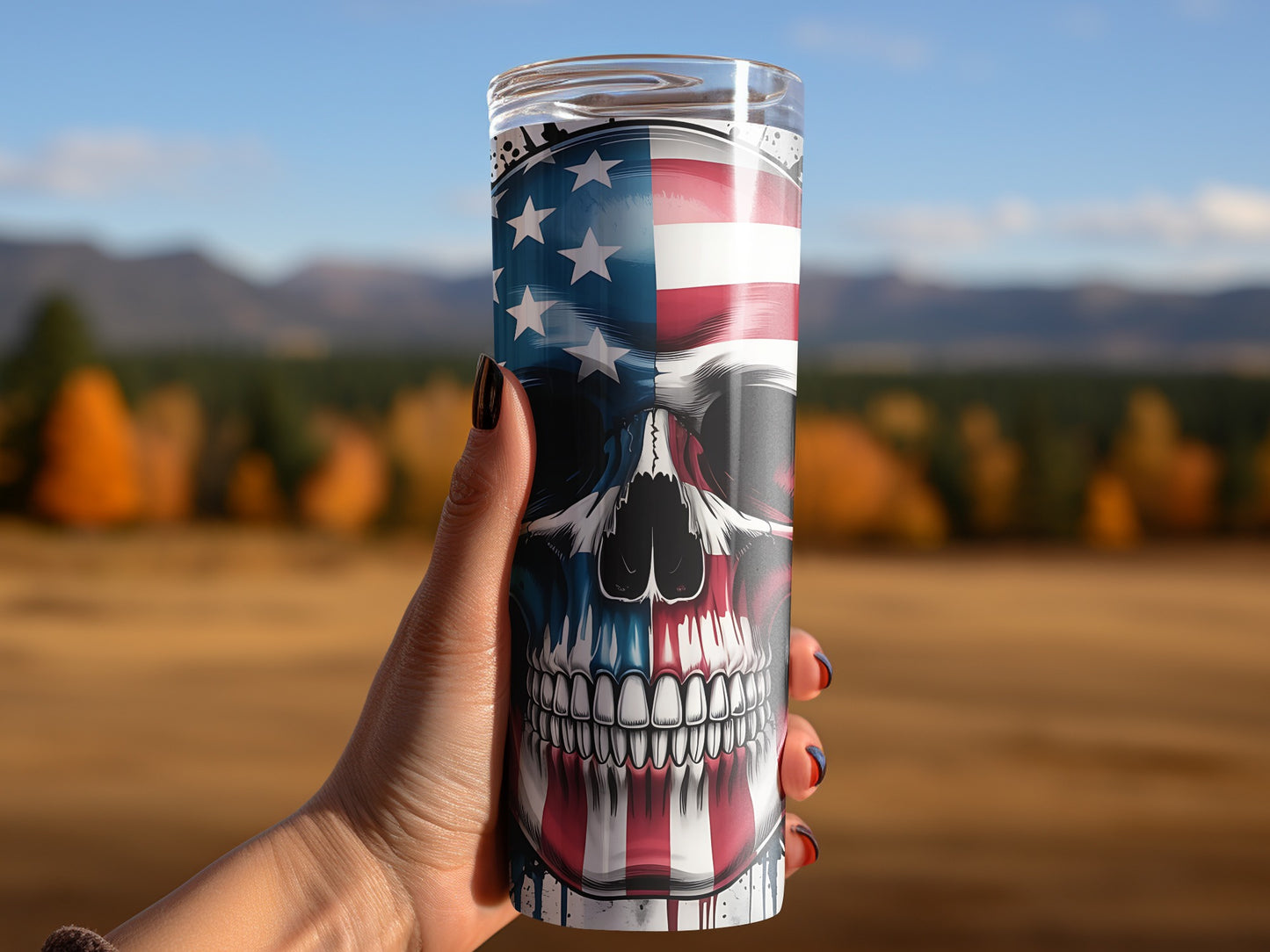 Tumbler with American flag skull design held in a hand.