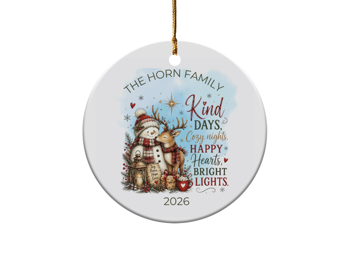 Round ceramic Christmas ornament printed with a snowman, reindeer, lantern, and the text The Horn Family 2026.
