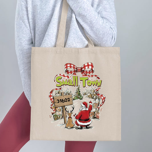 Tote bag with "Small Town 31602" design featuring Santa and a reindeer.
