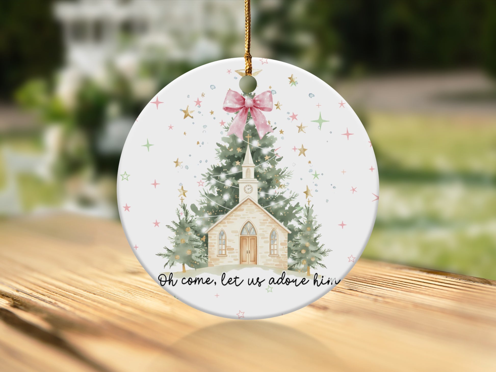 Christmas ornament with church, trees, stars, and text "Oh come, let us adore him".