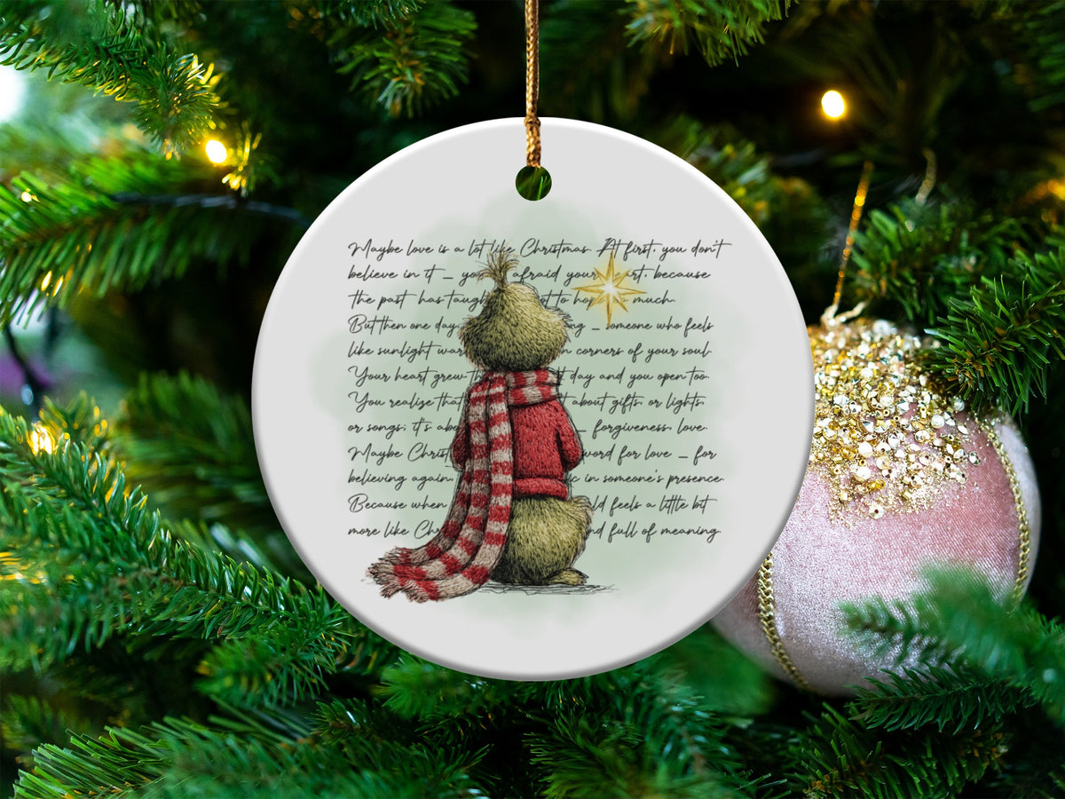 Round Christmas ornament with Grinch-like character and Christmas quote.