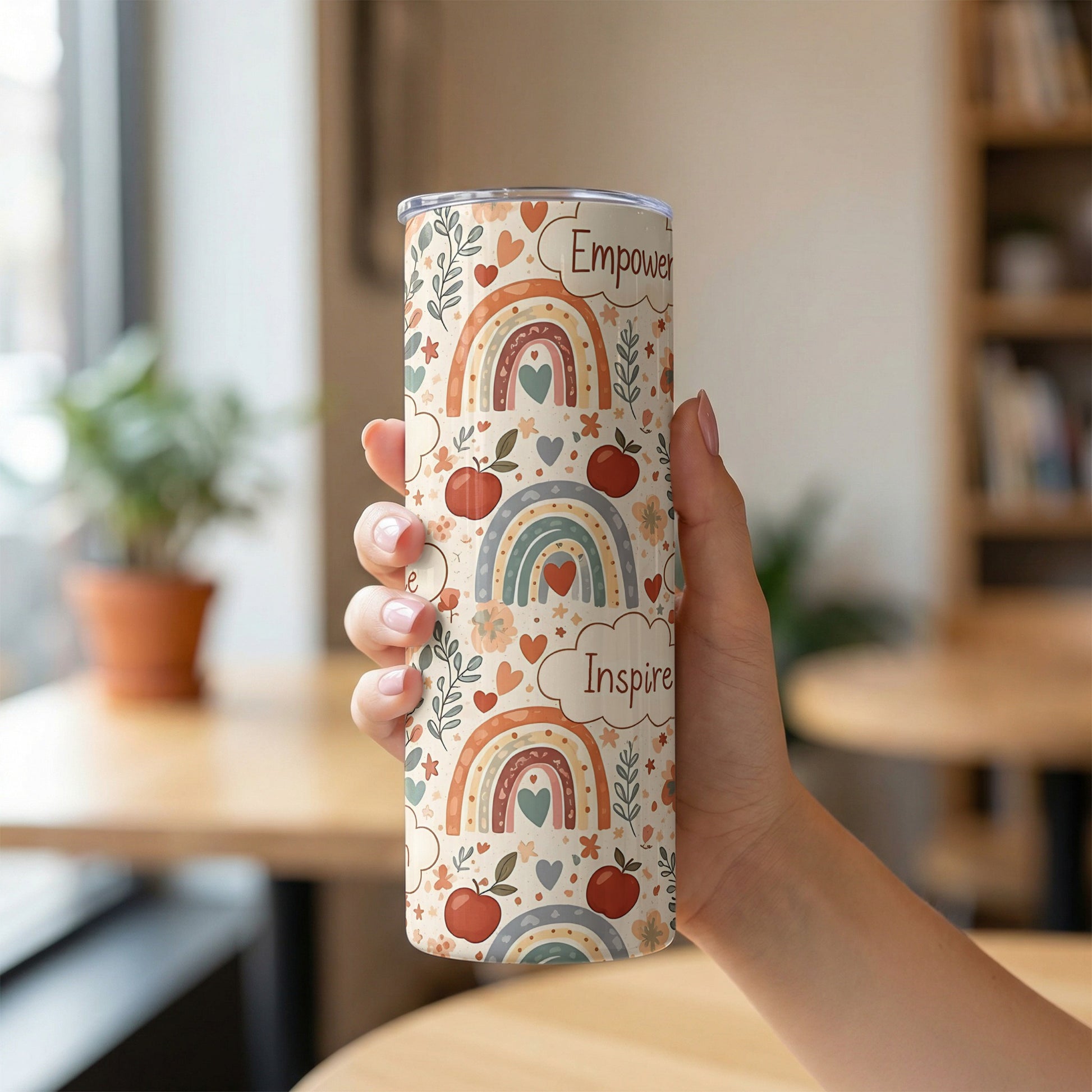 Tumbler with boho rainbow pattern and text "Empower" and "Inspire".