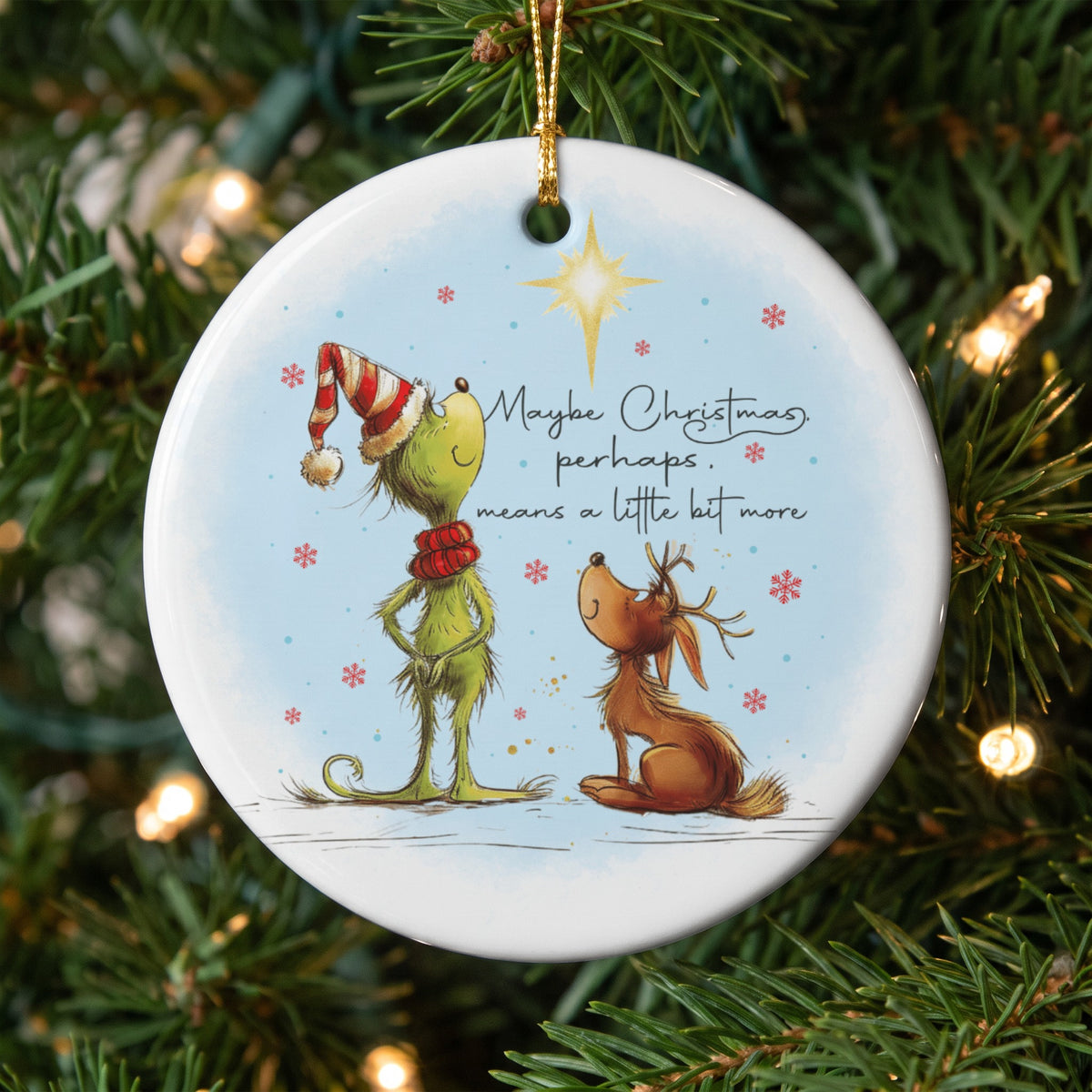 The Grinch and Max the dog look up at a star on an ornament with text.