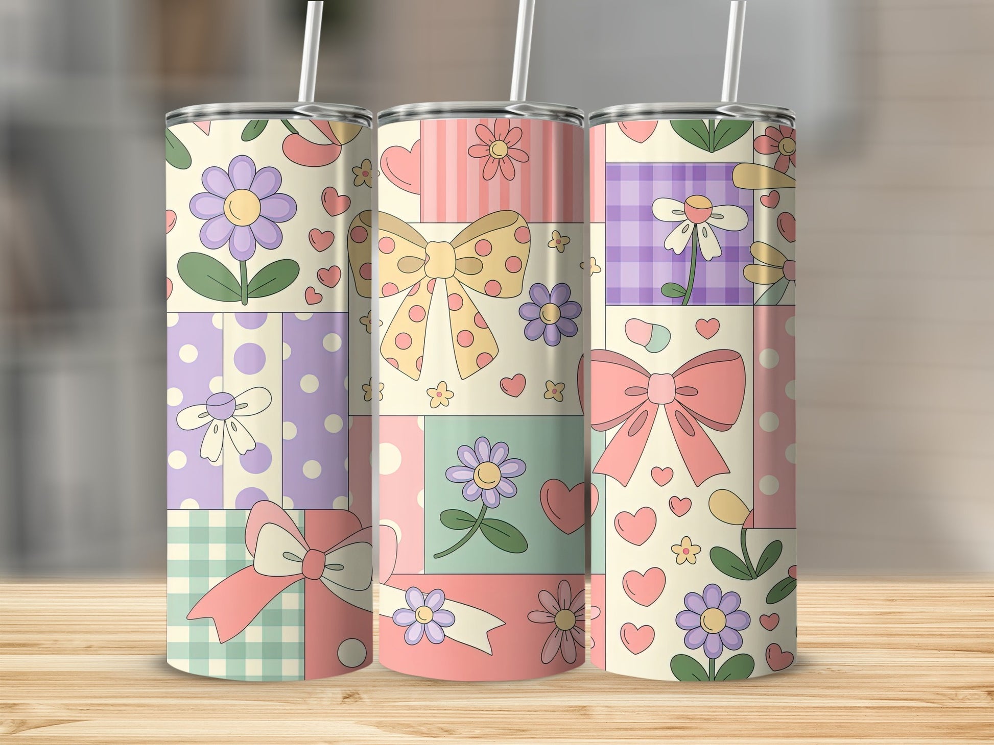 Three tumblers with a pastel patchwork design of flowers, bows, and hearts.
