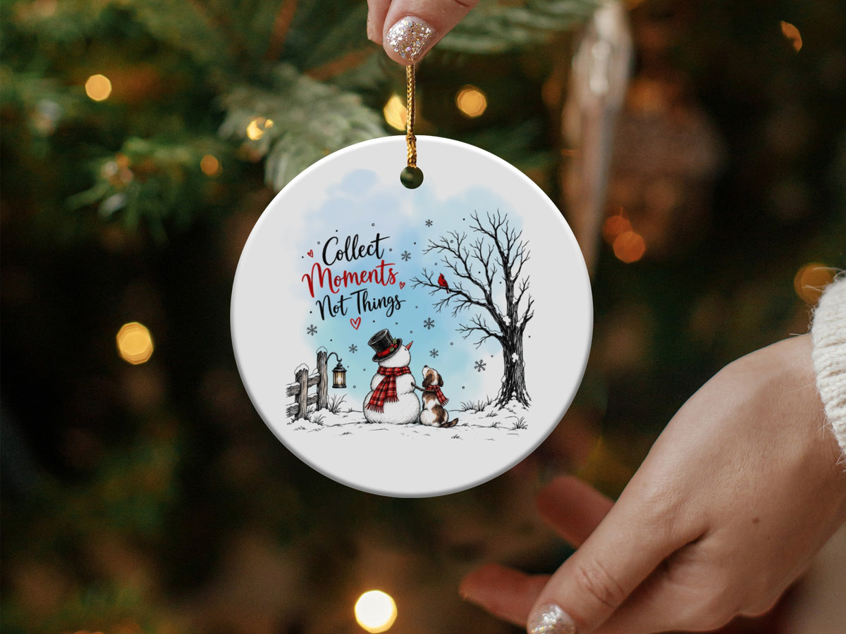 Round white ceramic Christmas ornament featuring a snowman, dog, and the text Collect Moments Not Things.