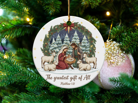 Christmas ornament depicting nativity scene, with text "The greatest gift of All, Matthew 1:21".