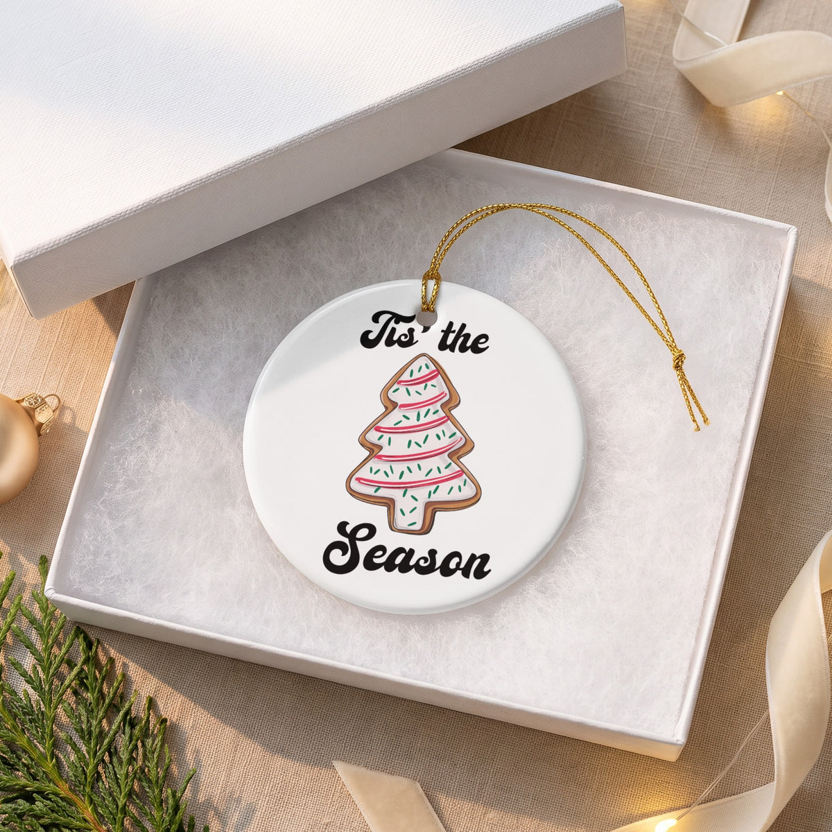 Round ceramic ornament with a Christmas tree cookie design and text.