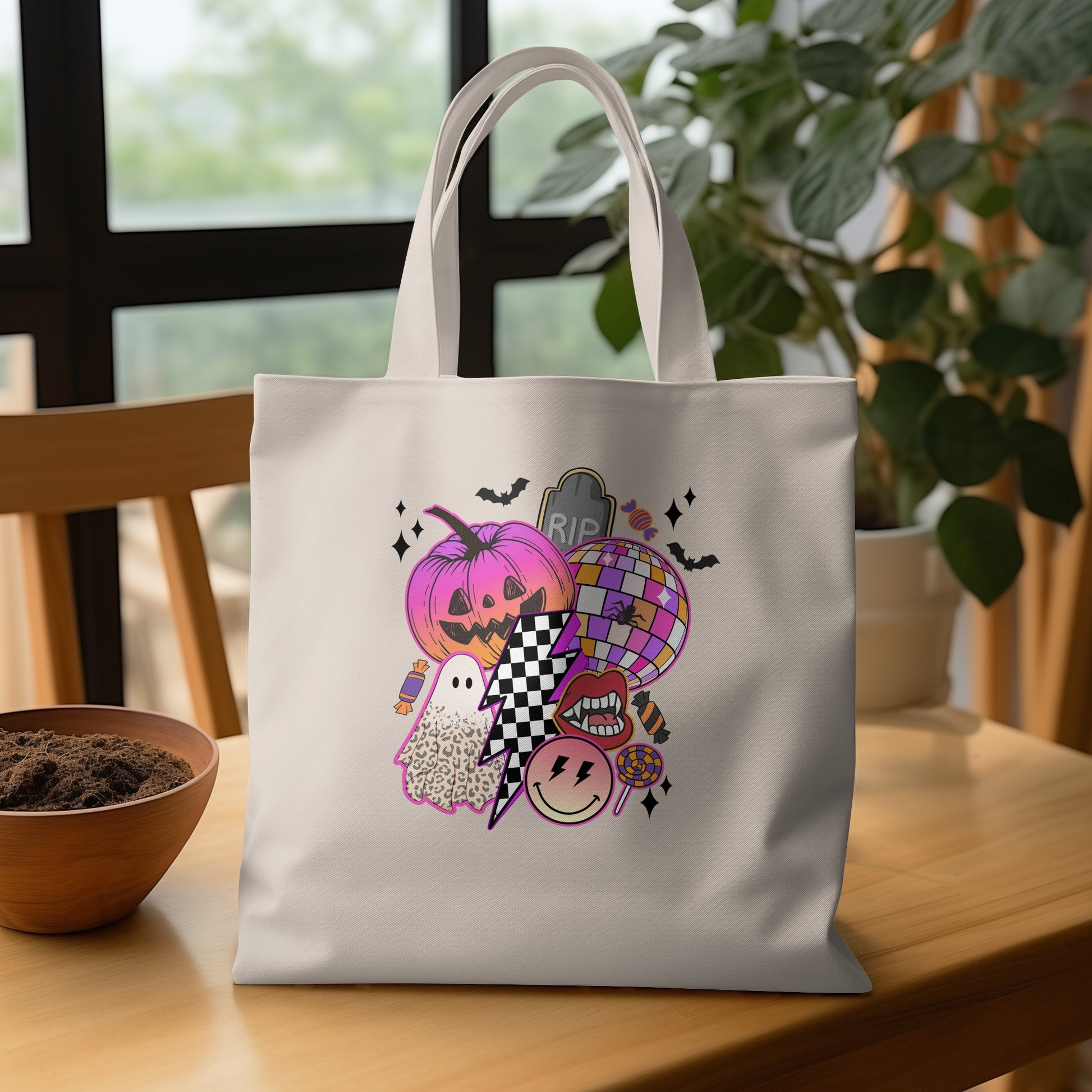 Tote bag with pink jack-o'-lantern, ghost, disco ball, and Halloween motifs.