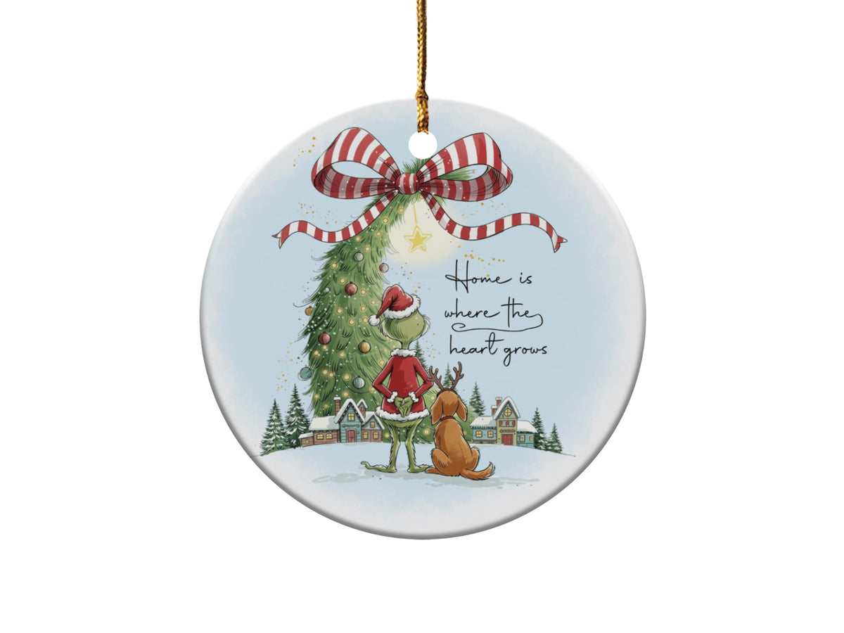 Grinch and Max with Christmas tree and village, "Home is where the heart grows" text.