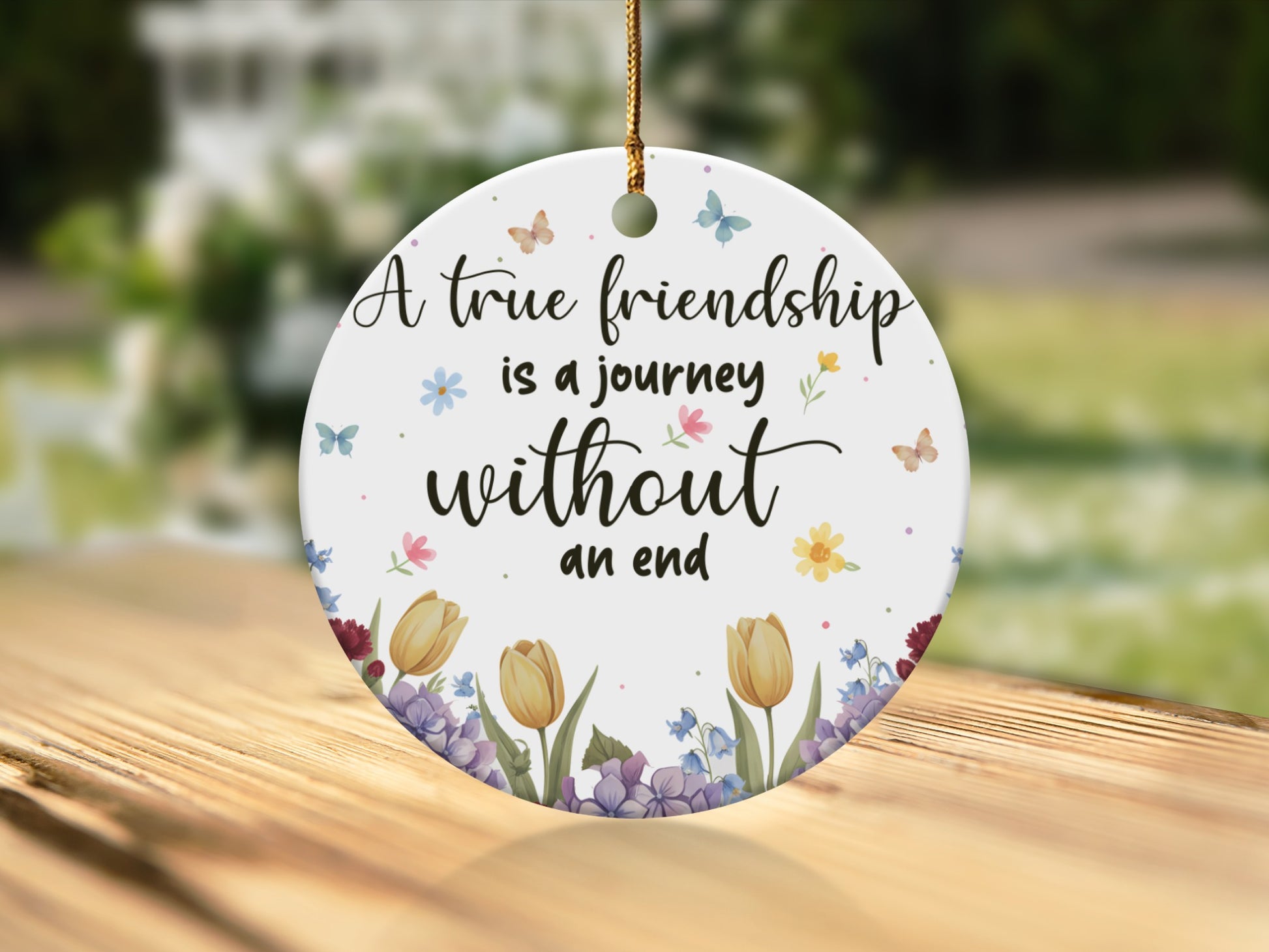 Round ornament with "A true friendship is a journey without an end" quote.