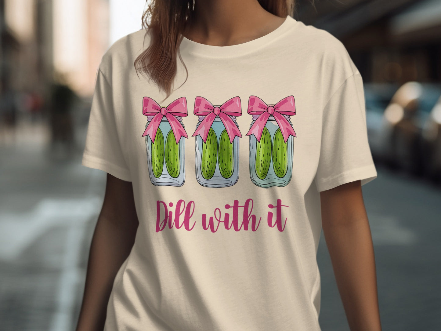 T-shirt with three jars of pickles with pink bows and "Dill with it" text.
