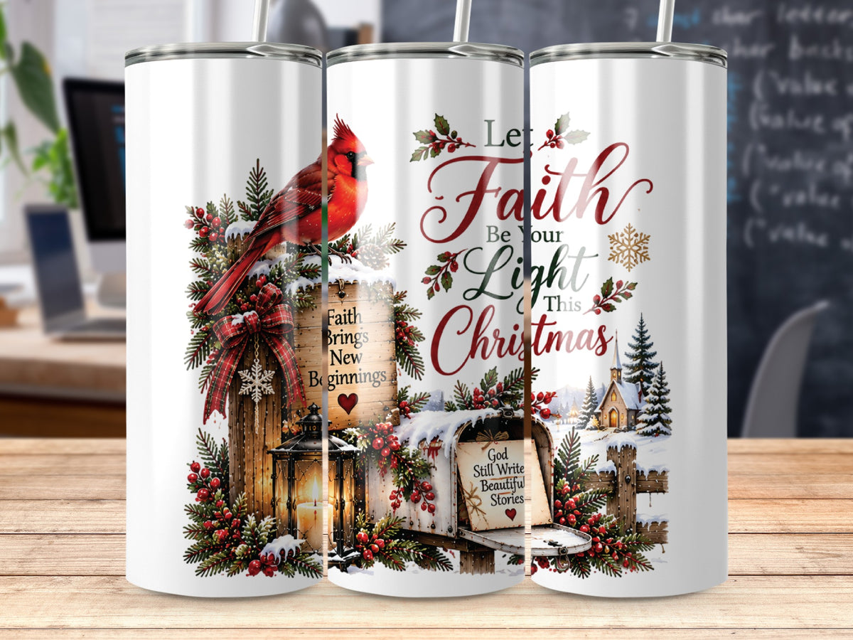 Three white stainless steel tumblers stand on a wooden surface, displaying a Christmas-themed winter design featuring a cardinal, snow, and inspirational text.