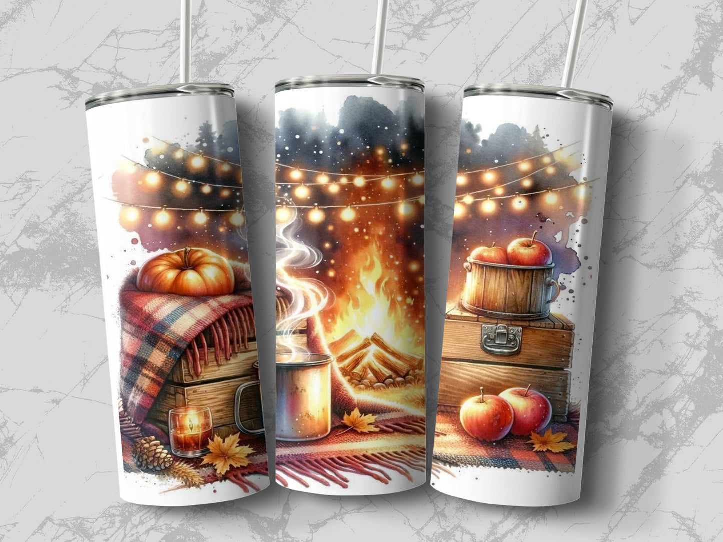Three tumblers with autumn campfire scenes and string lights.