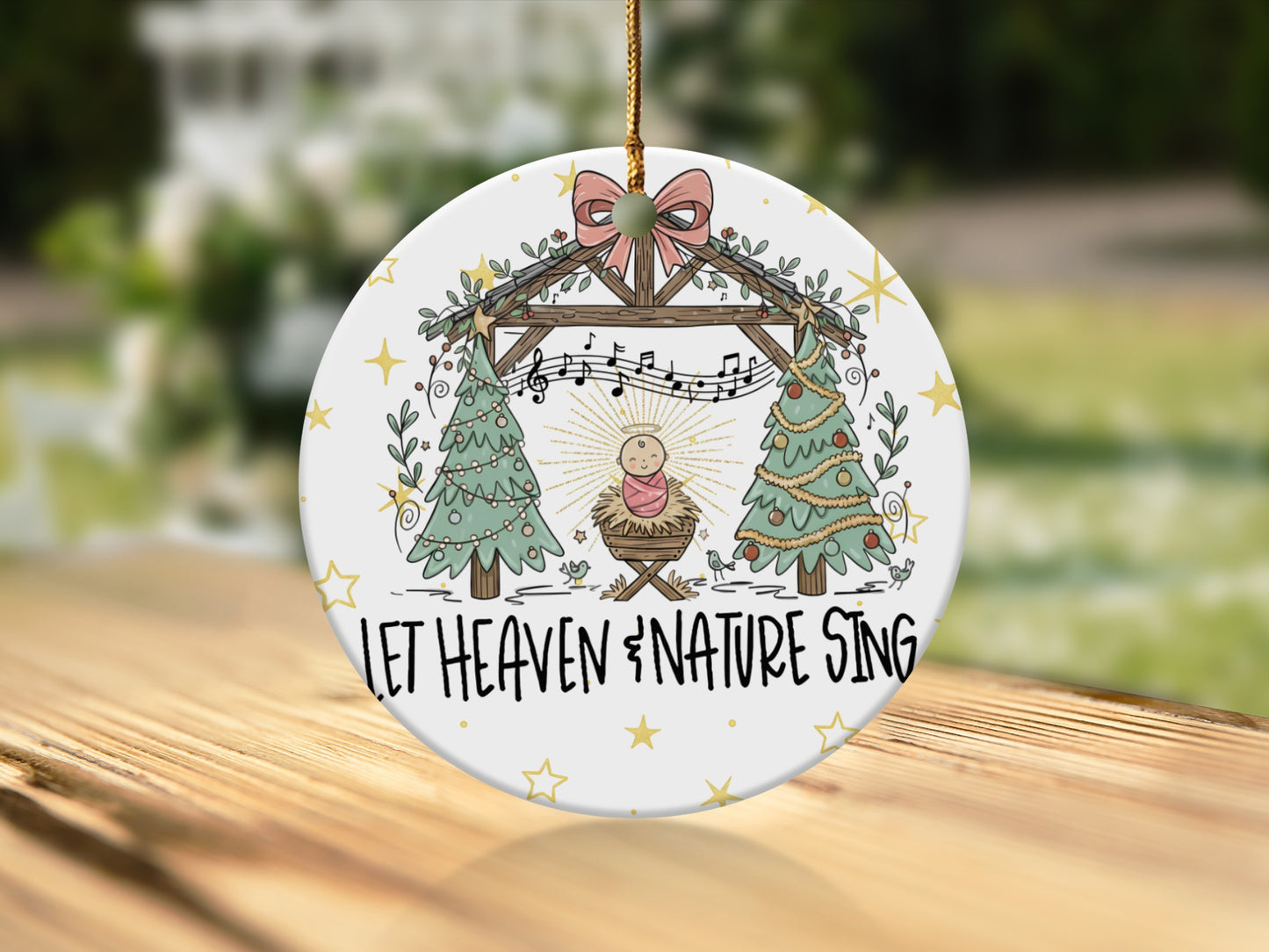 Christmas ornament with Nativity scene and "Let Heaven & Nature Sing" text.