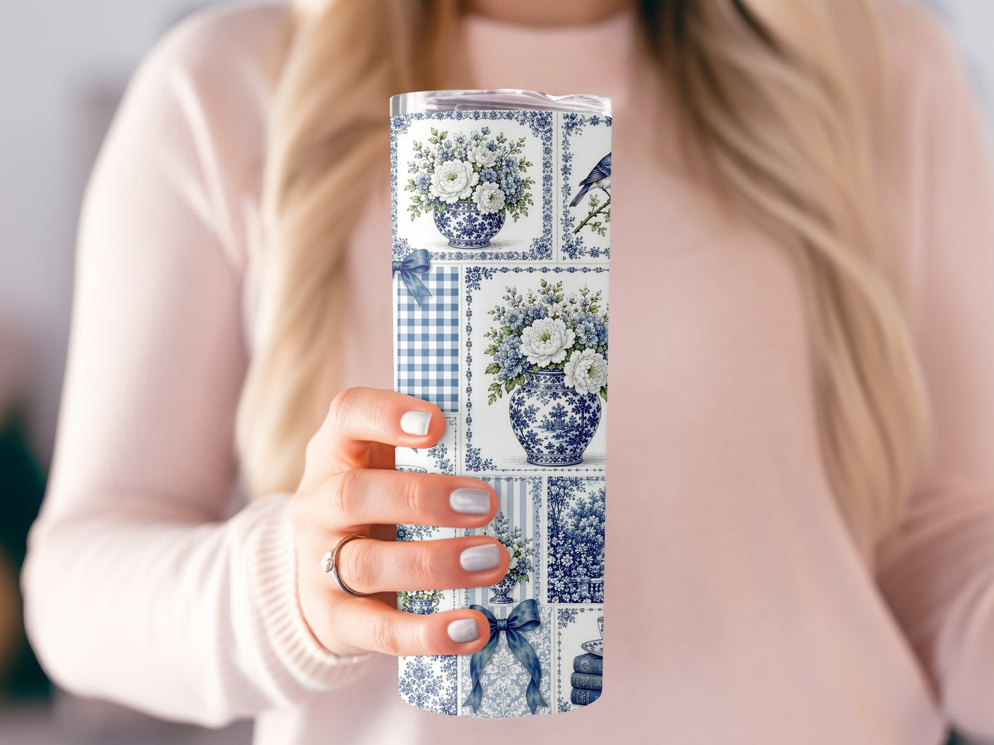 Blue and white patterned tumbler with floral, bird, and gingham designs.