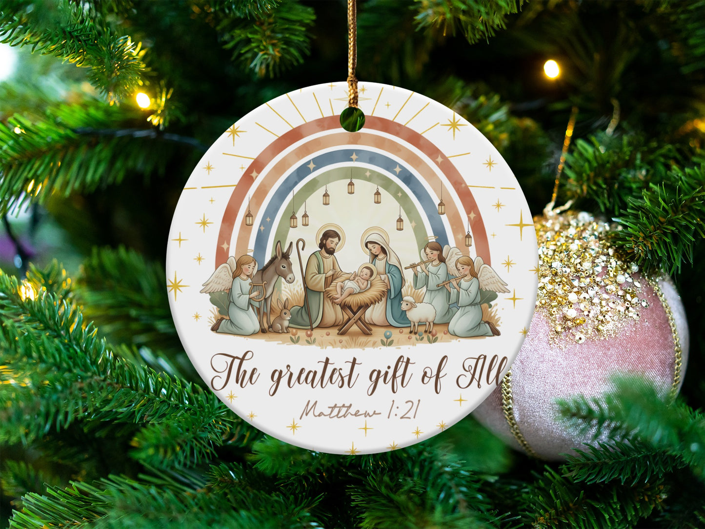 Nativity scene ornament with rainbow and text "The greatest gift of All".