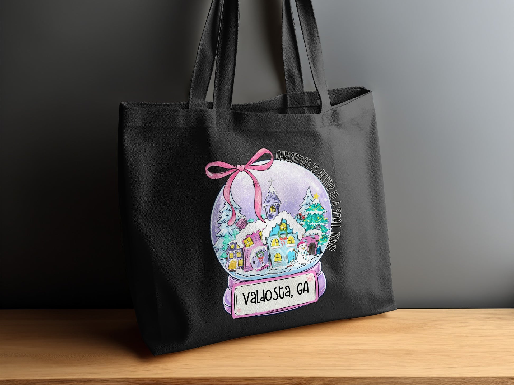 Black tote bag with a snow globe design featuring Valdosta, GA.