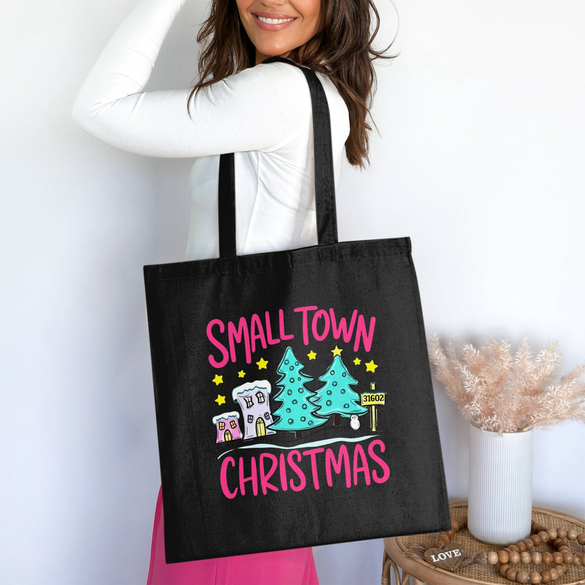 Black tote bag with "Small Town Christmas" text and festive holiday graphics.