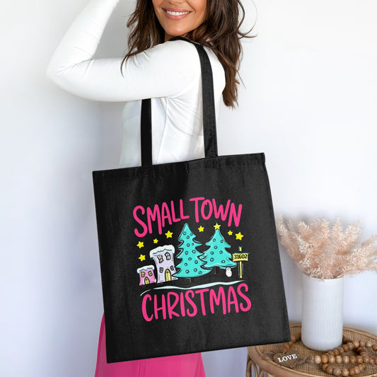 Black tote bag with "Small Town Christmas" text and festive holiday graphics.