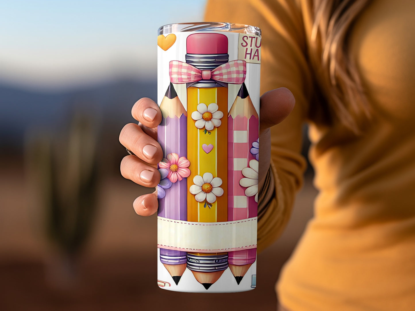 Tumbler with pencils, bows, hearts, and flowers.