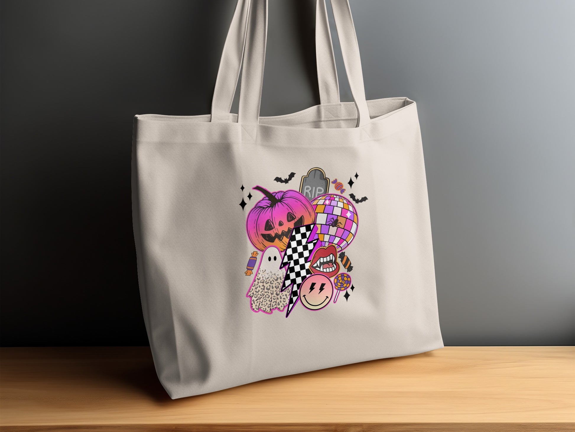 Halloween-themed graphic on a light-colored tote bag with pumpkin, ghost, disco ball, and lips.
