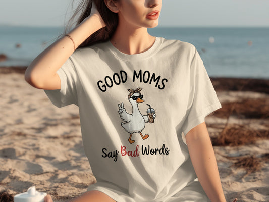 White t-shirt with "Good Moms Say Bad Words" and a peace-sign goose.