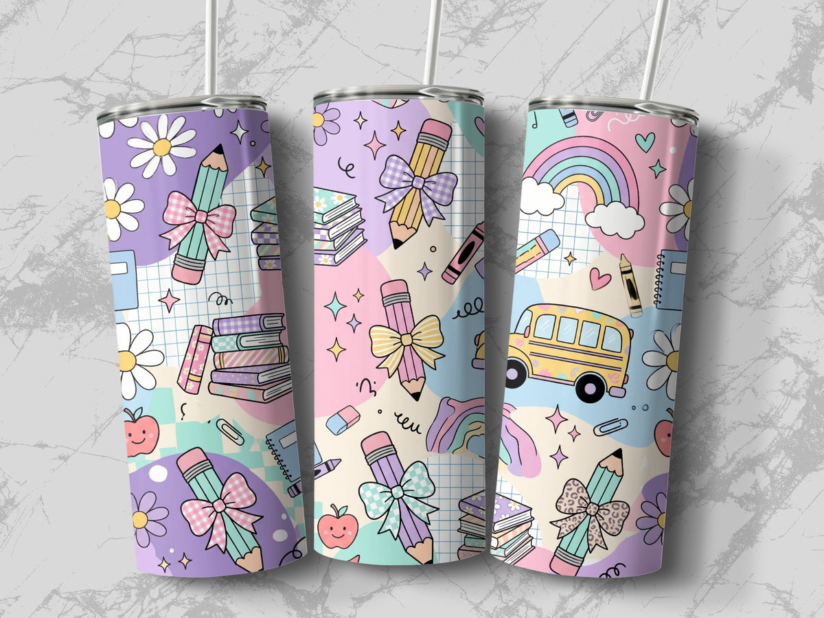 Three tall, skinny travel mugs with pastel school-themed patterns featuring pencils, bows, books, and rainbows.