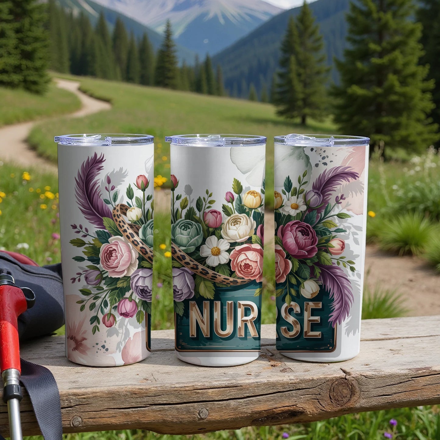 Three floral tumblers with "NURSE" text on a wooden table outdoors.