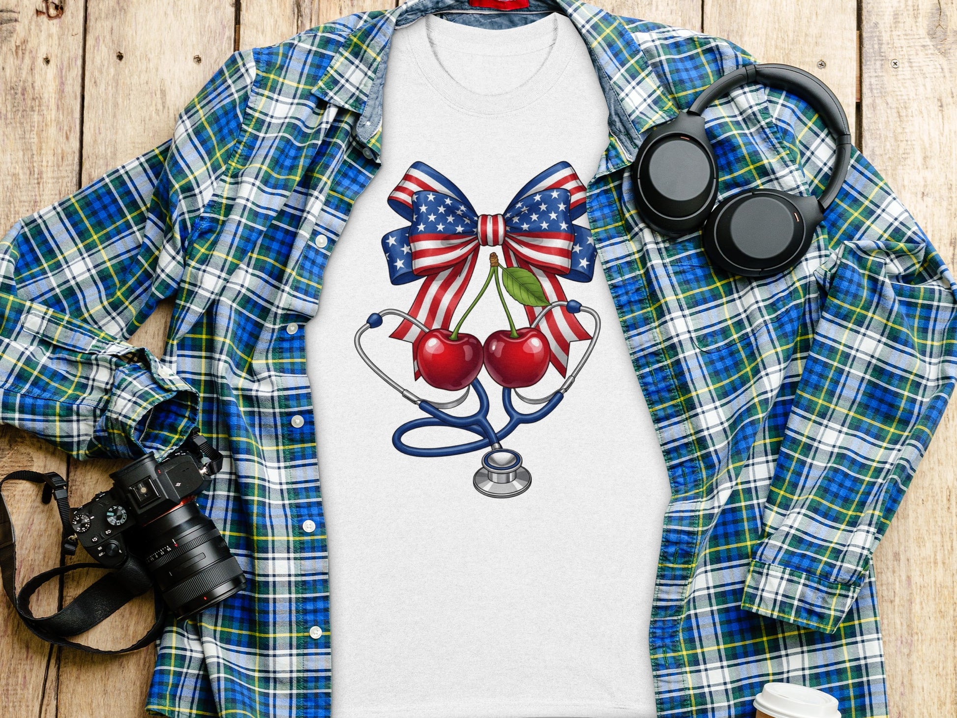 White t-shirt with cherry, stethoscope, and American flag bow design.