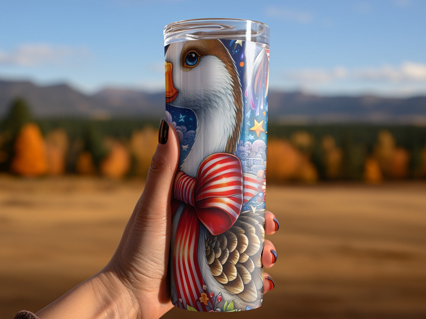 Goose wearing a striped ribbon, held by a hand against a blurred autumn landscape.
