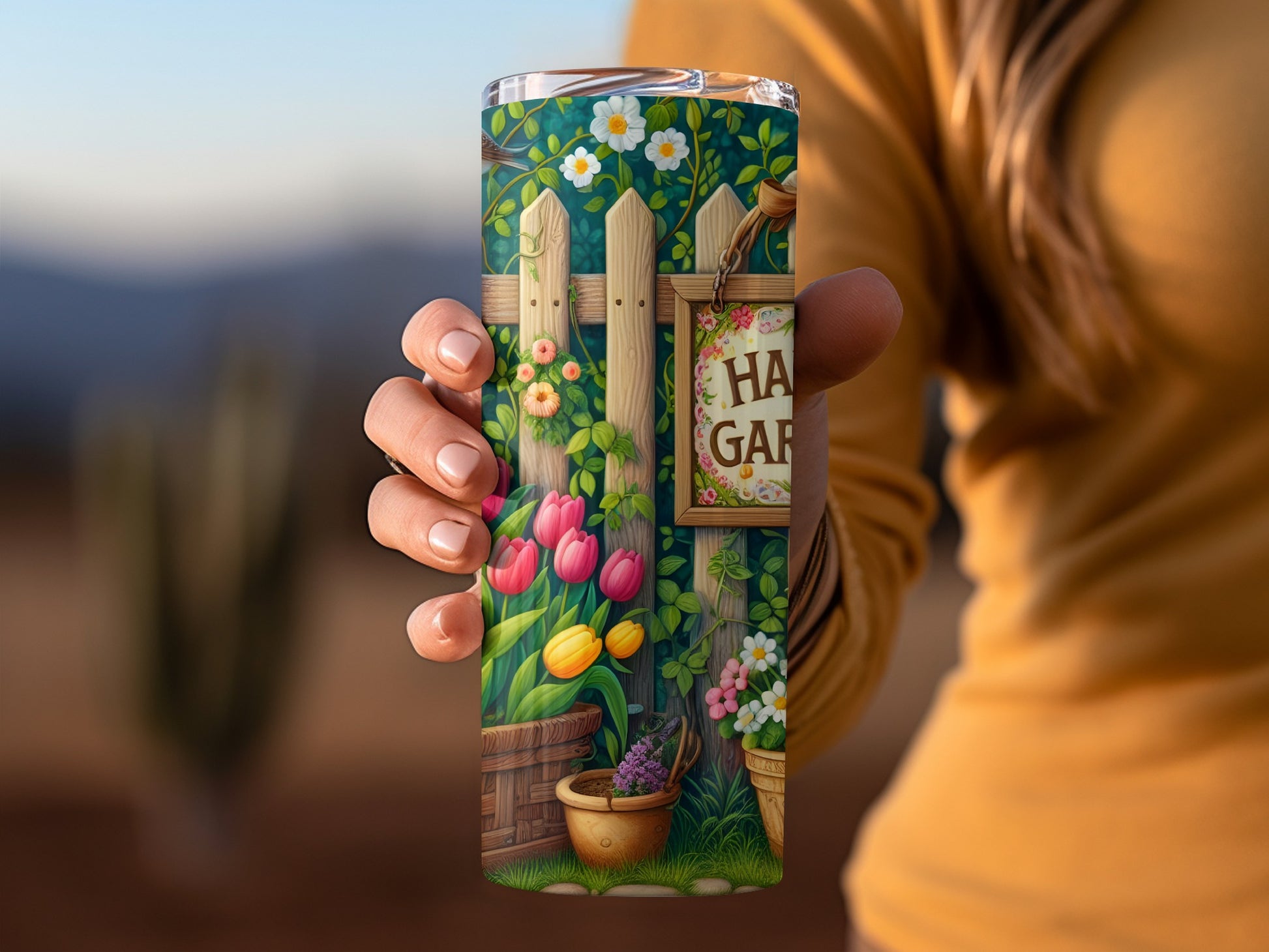 Tumbler featuring tulips, flowers, and "Happy Garden" sign against blurred background.