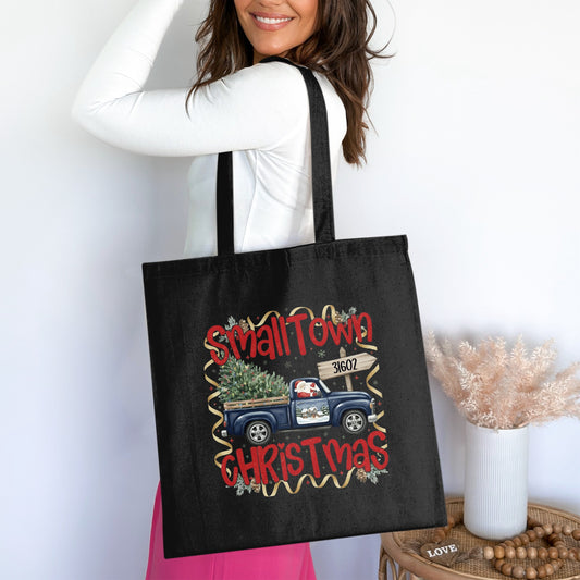 Black tote bag with "SmallTown Christmas" text and Santa in a truck graphic.