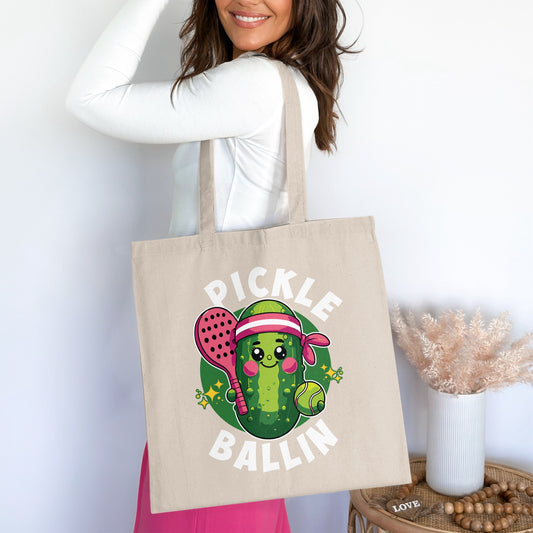 Tote bag featuring a cartoon pickle playing tennis with text "Pickle Ballin'".