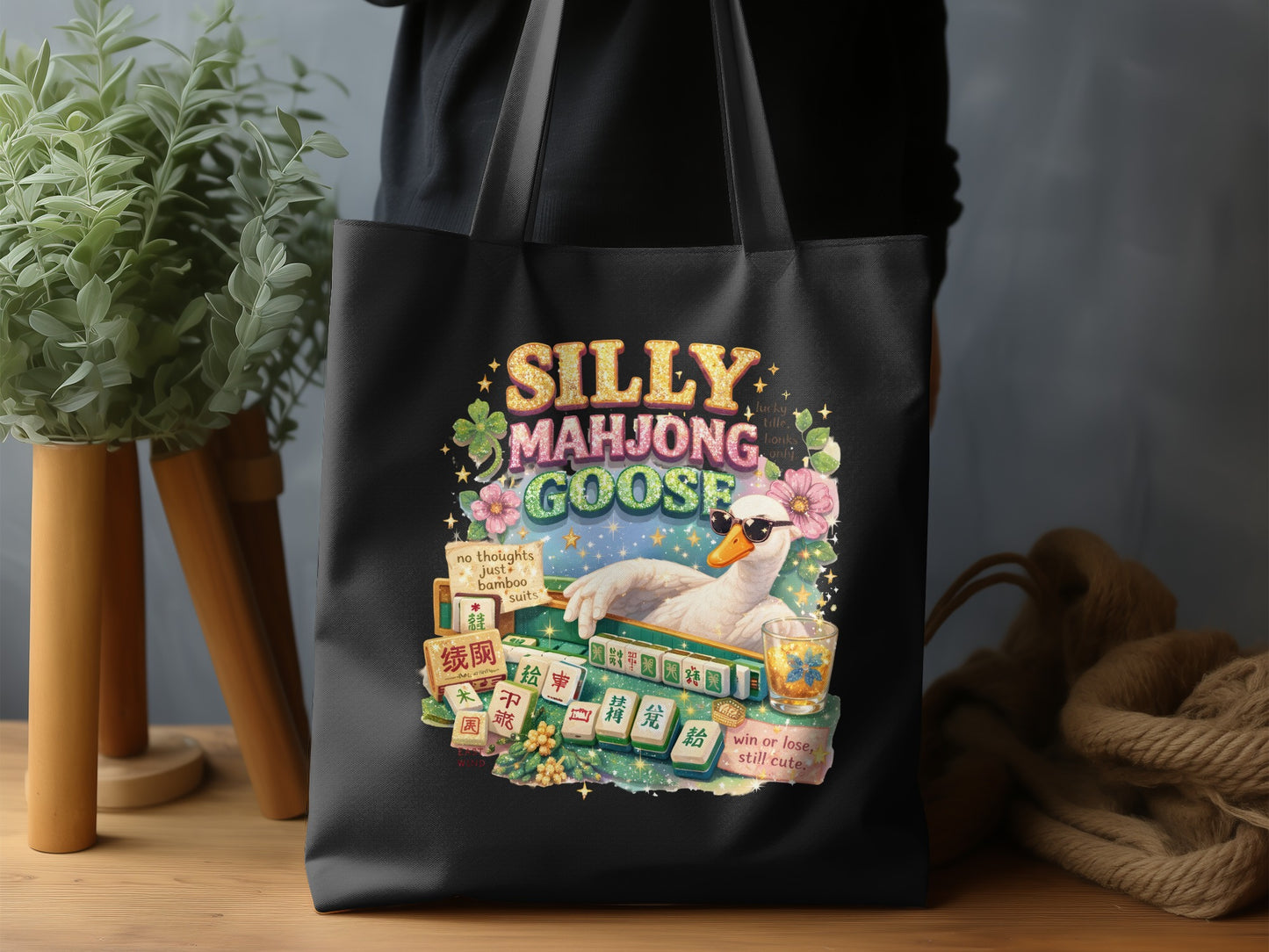 Black tote bag with a goose wearing sunglasses playing Mahjong with whimsical text.