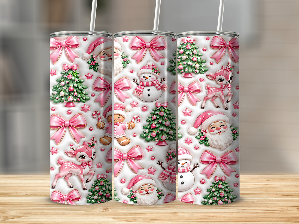 Three matching metal tumblers with straws feature a whimsical pink and white Christmas pattern with Santa, reindeer, trees, and bows.