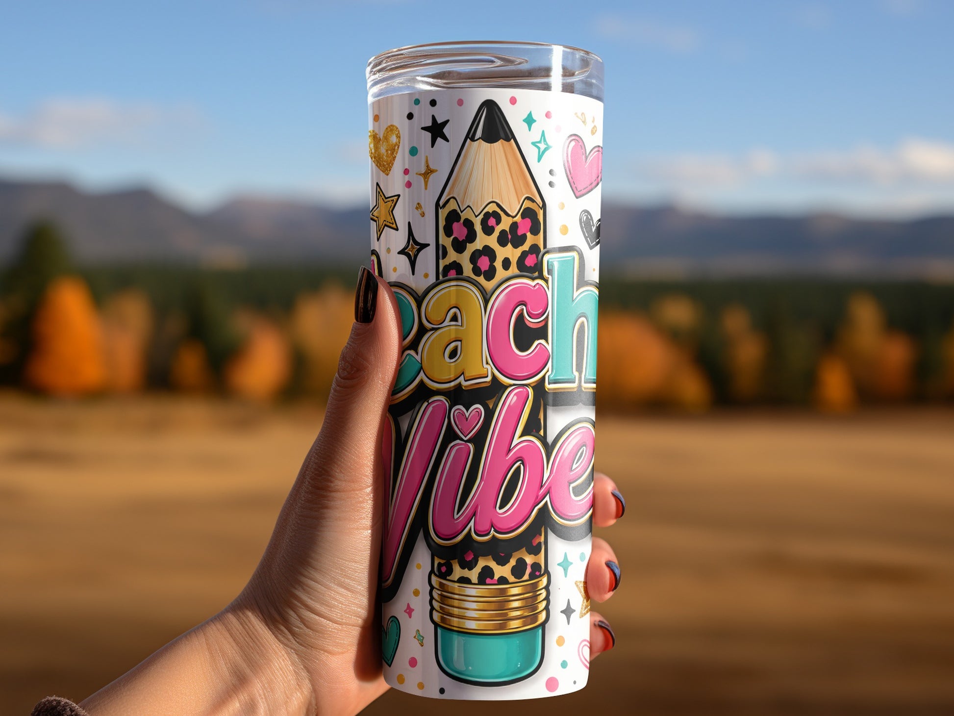 Tumbler with "Peach Vibe" text, pencil graphic, and colorful icons, held by a hand.