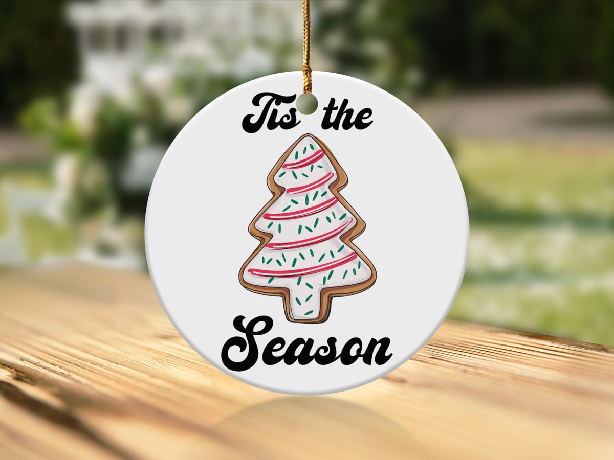 Round ornament with a Christmas tree cookie design and text "Tis the Season".