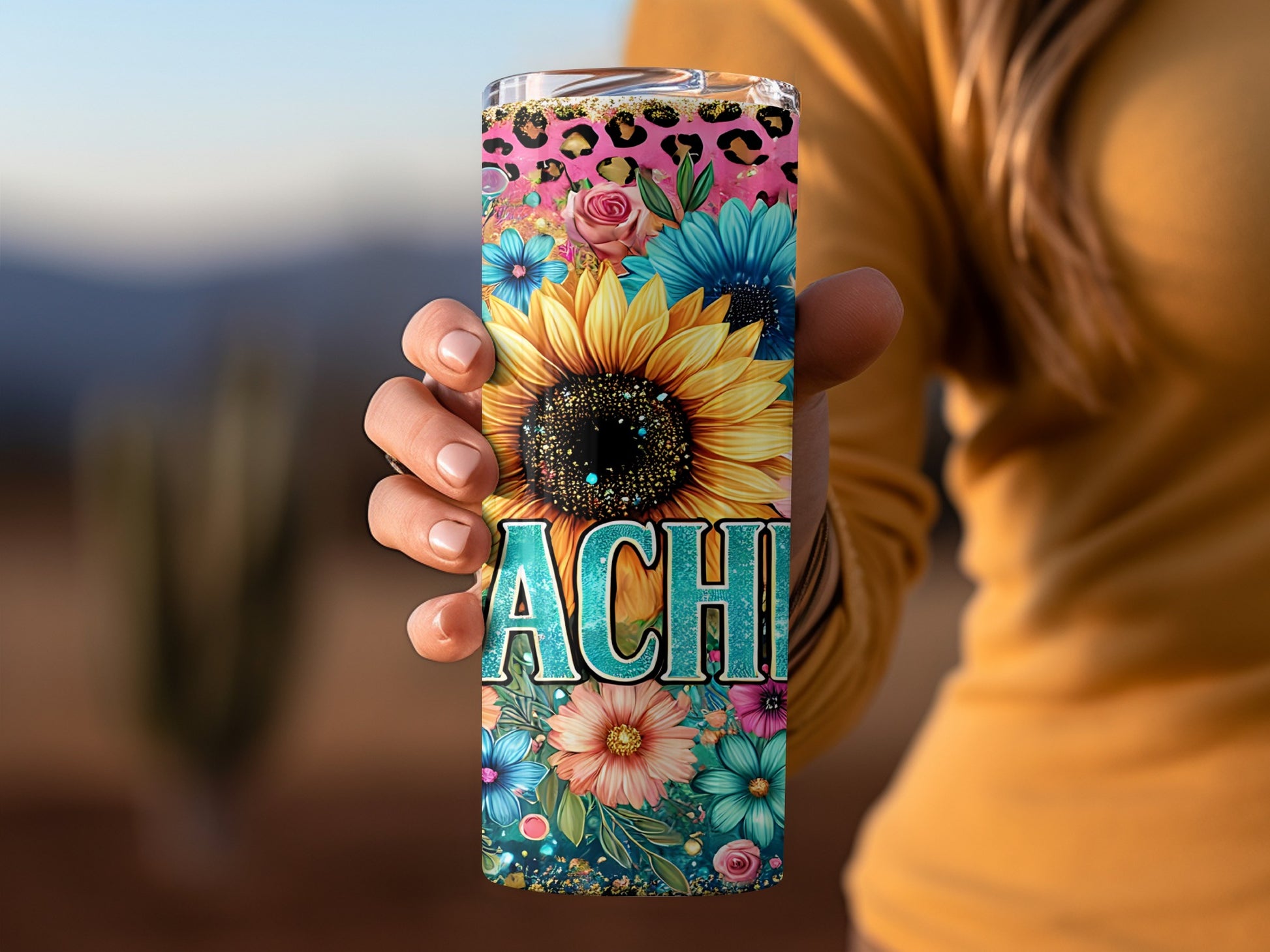 Tumbler with floral designs, leopard print, and the name "ACHI".