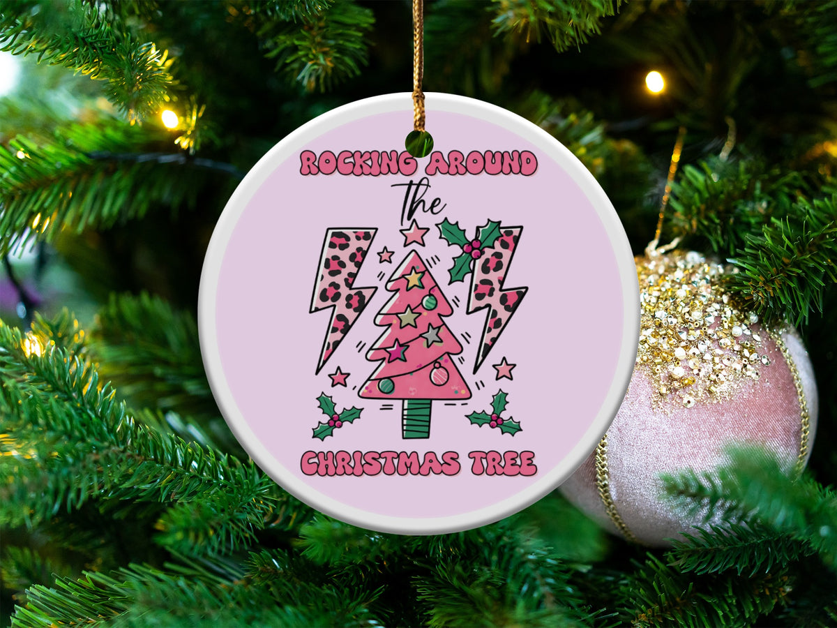 Round ornament with text "Rocking Around the Christmas Tree" and a pink tree with leopard print lightning bolts.