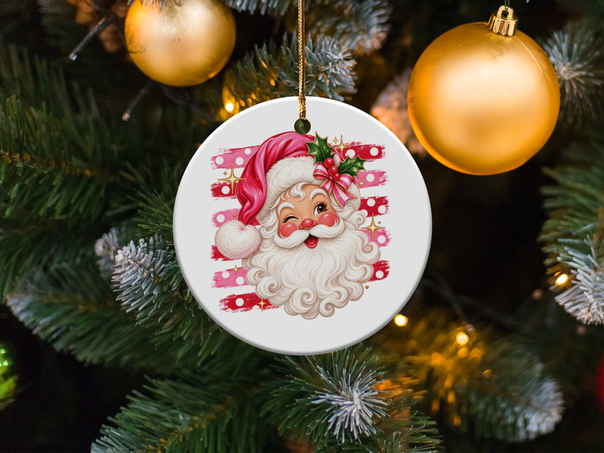 Round ornament with winking Santa Claus against a pink and white striped background.