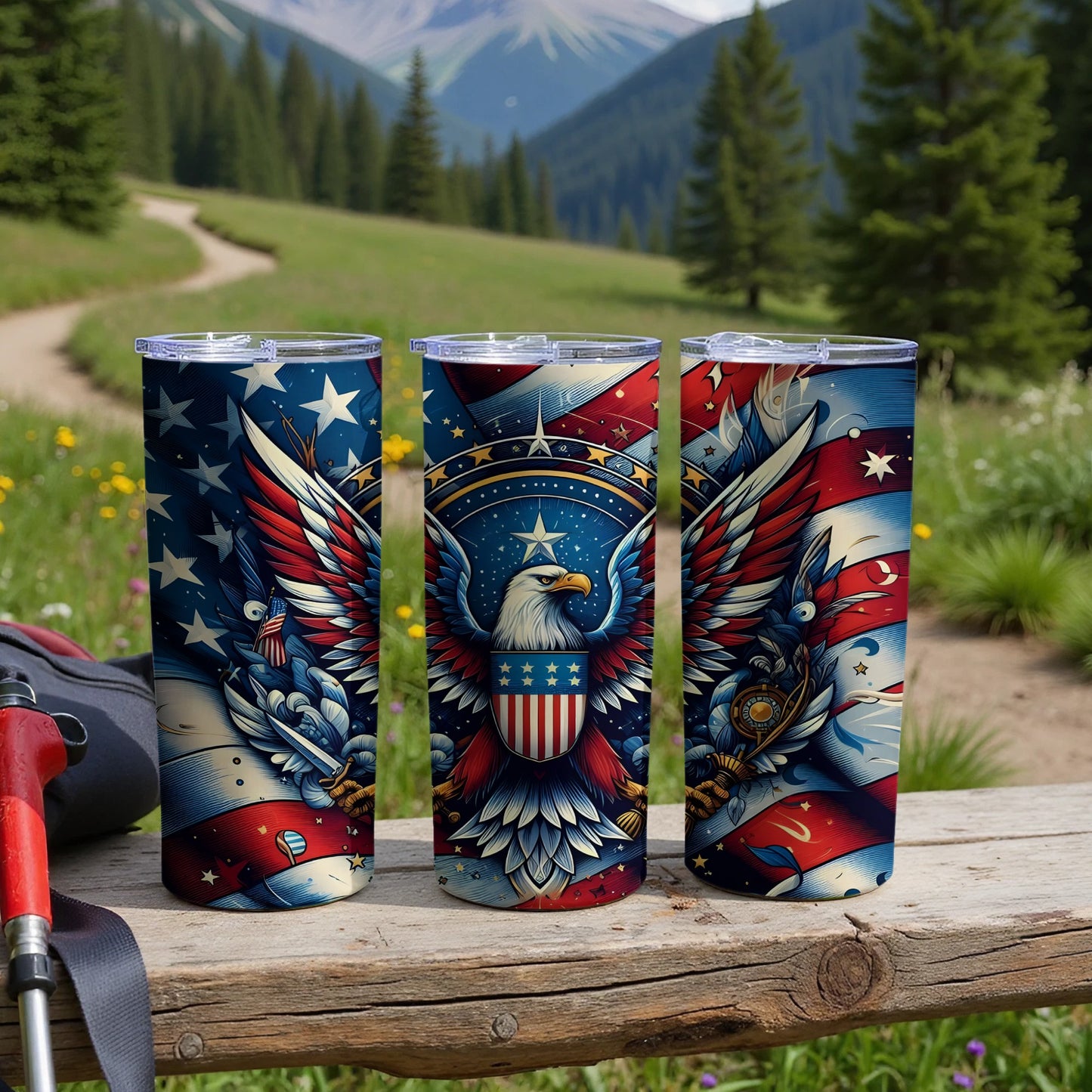Three patriotic tumblers with eagles and stars displayed outdoors.