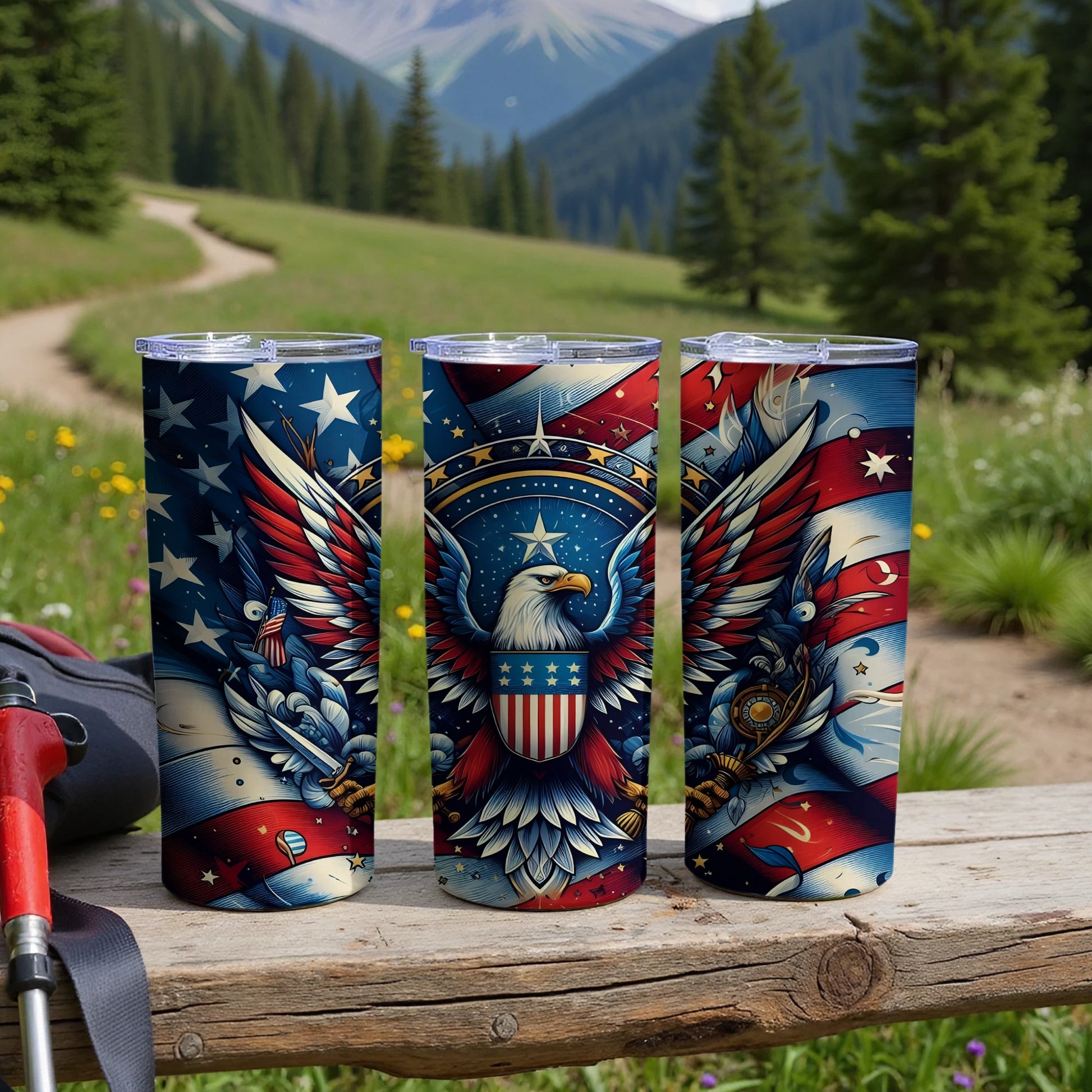 Three patriotic tumblers with eagles and stars displayed outdoors.